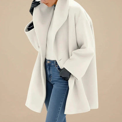 Woman wearing a white oversized A-line coat