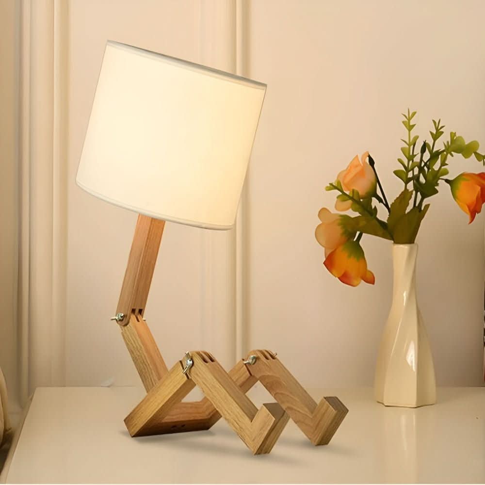 Wooden robot lamp sitting on a white sideboard