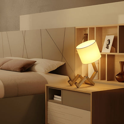 Wooden robot lamp on a bedside table