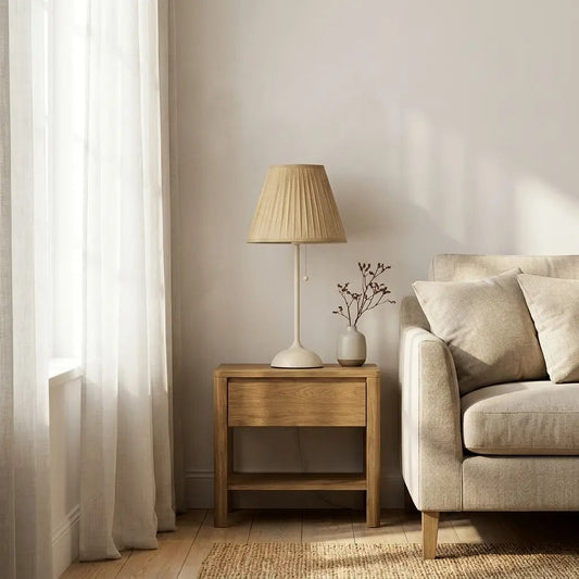 Pleated fabric table lamp on a side table in a living room