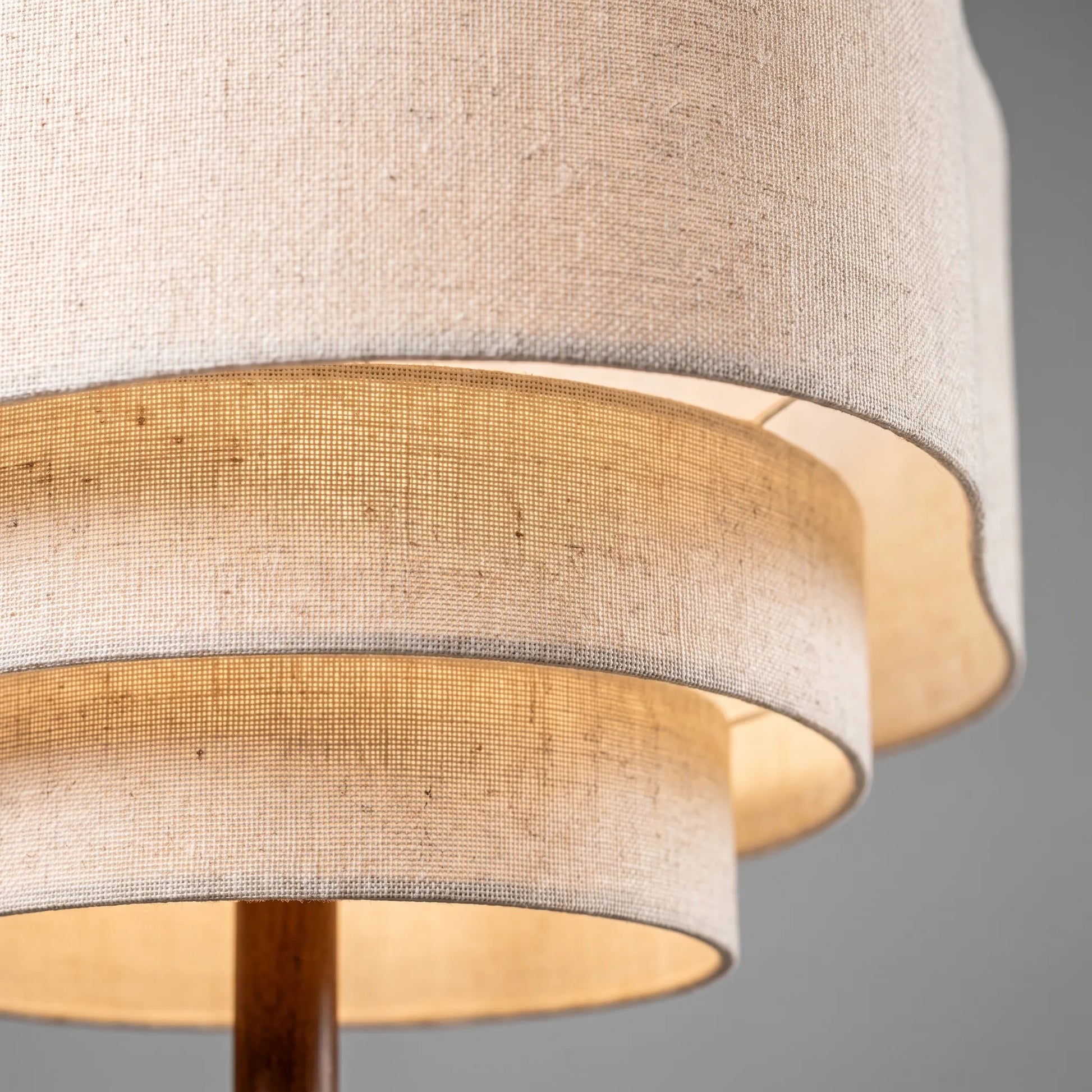 Close-up of the woven linen shades and walnut stem
